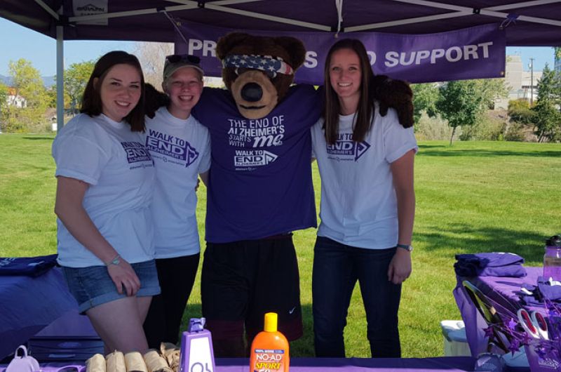 UMGS members and Monte the bear help at the merchandise table