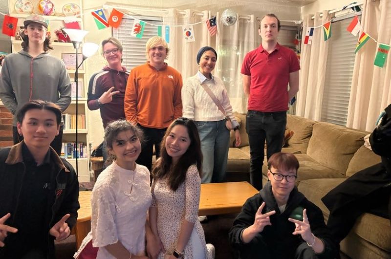 Group of people inside a house smiling for a photo