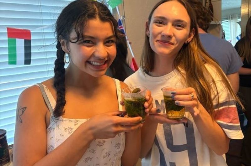Two girls holding tea cups