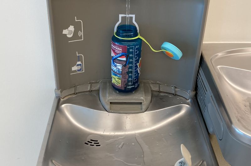 a water bottle being filled up at a station