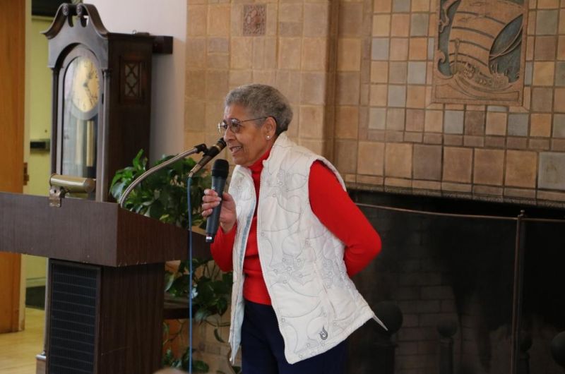 Dr. Hewitt speaks into a microphone