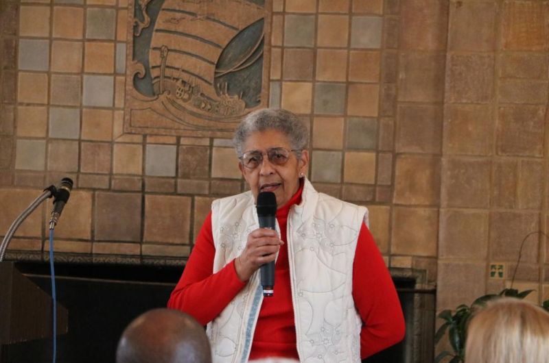 Dr. Hewitt speaks into a microphone