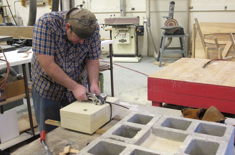 Brad Allen secures a strap around one of the molds.