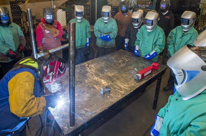 Girls from the GRIT program watch a welding demonstration.