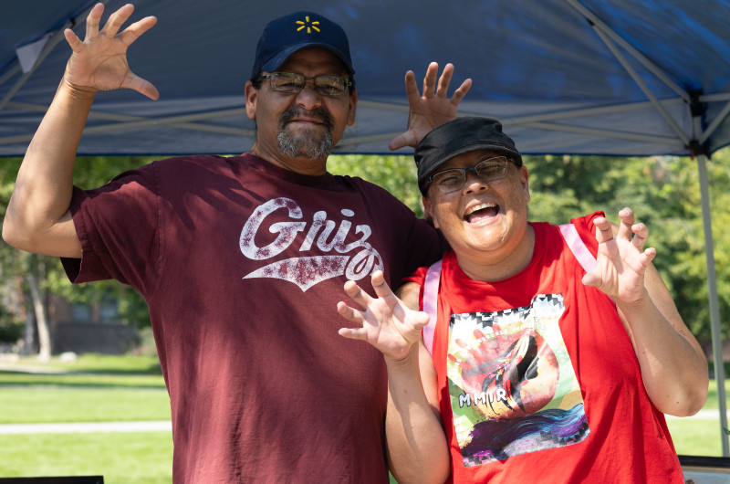 Two Students at welcome feast showing their best Grizzly bear stance 