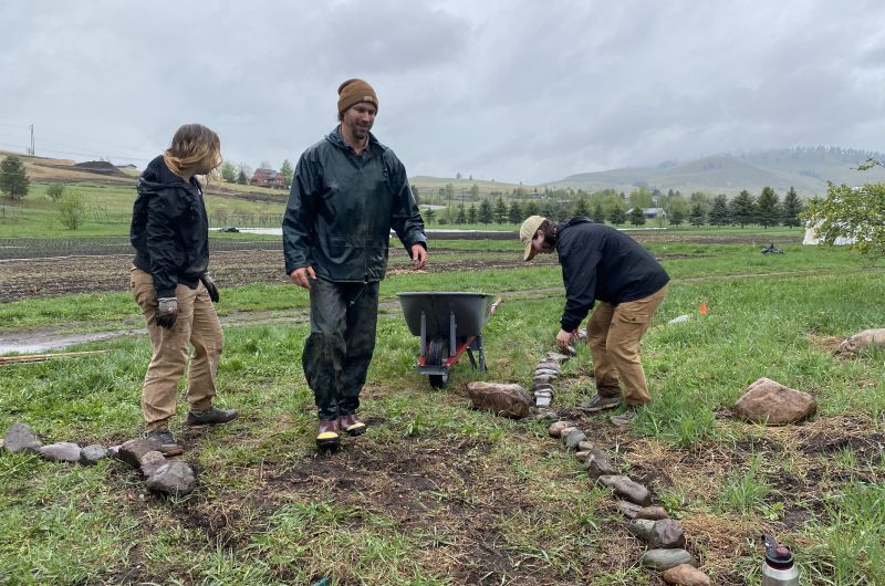 Volunteers making a pathway in the garden