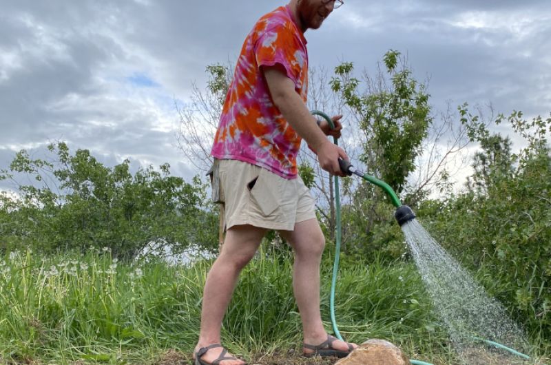 kaleb watering rock garden