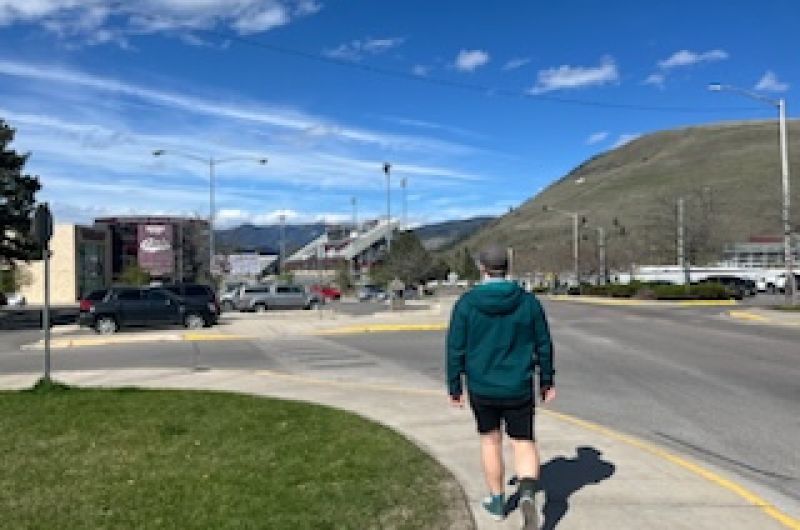 The author leads a soundwalk. Shot from behind. Mountains in background; industry in foreground.