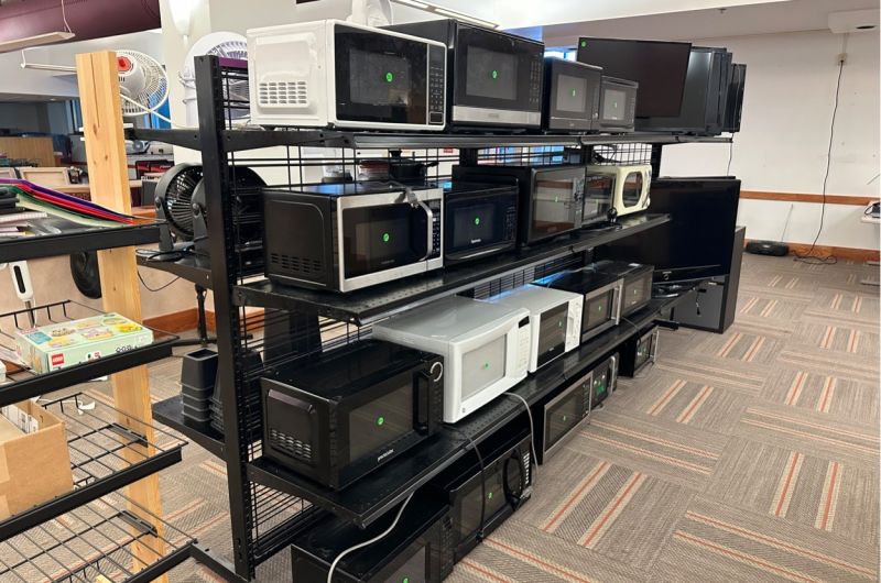 row of microwaves on display