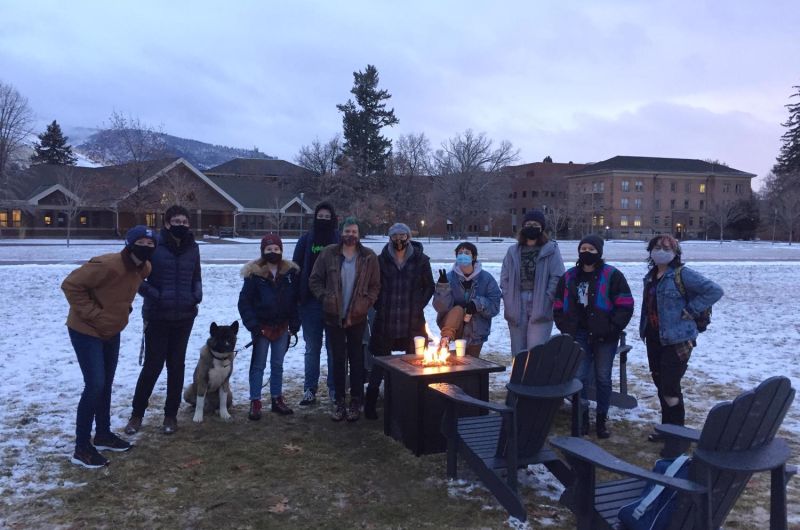 Studetns gathered around a fire pit to celebrate rainbow welcome