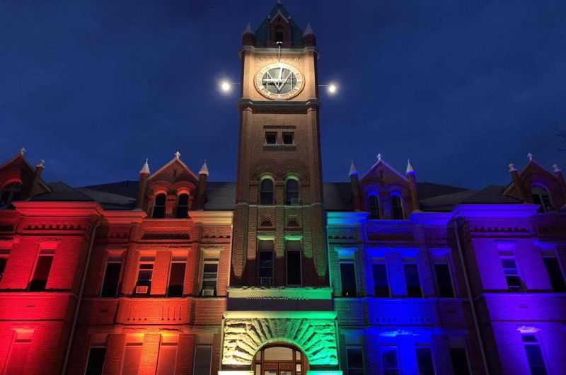 Main Hall lit up with pride flag colors