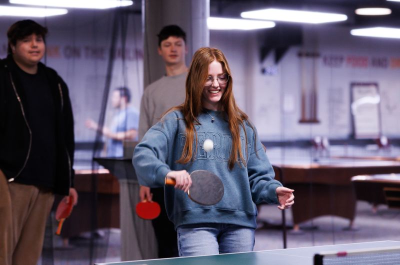 girl hitting a ping pong ball