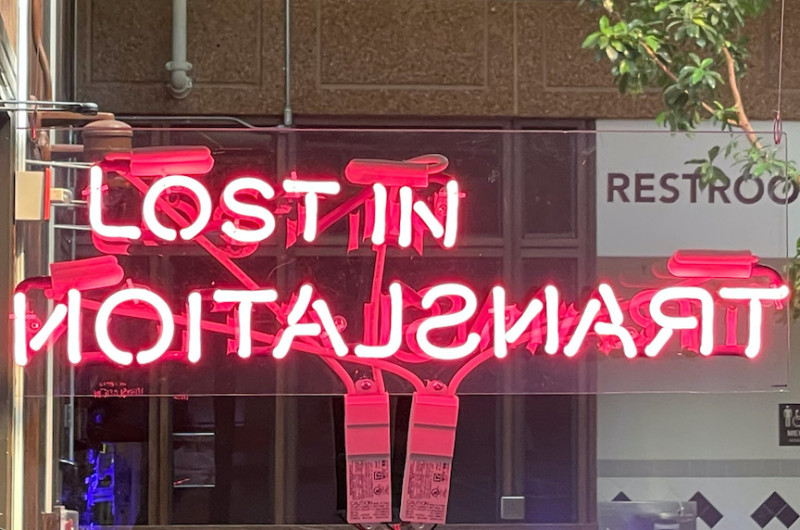 neon sign in hot pink reading 'lost in translation'
