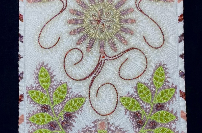 leatherwork purse with beadwork in the design of bitterroot flowers and huckleberries with leaves