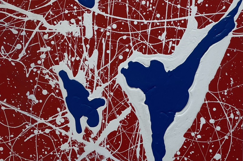 abstract painting, red backdrop with large white and dark blue splatters