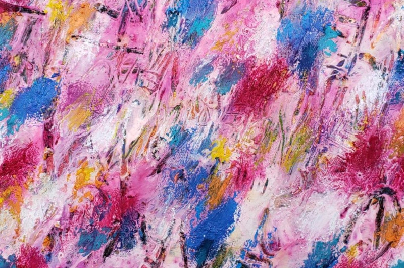 abstract painting with dabs of bright blue, pink, yellow, orange, white, and pale pink. illegible text is inscribed through the paint layer onto a charcoal layer below