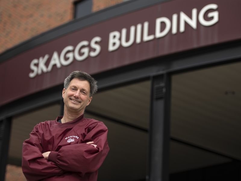 Prof. Curtis Noonan in front of Skaggs Building