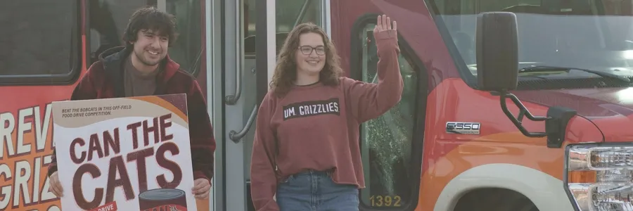Students participate in the Stuff the Bus event during the Can the Cats food drive 