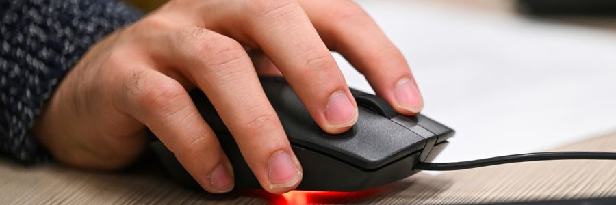 close up view of a hand holding a laser computer mouse
