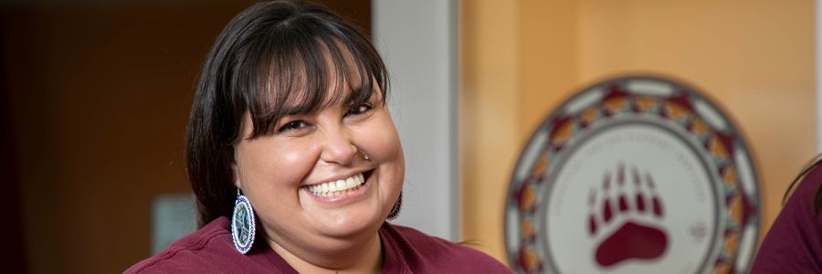 headshot of a smiling UM staff member wearing a maroon shirt