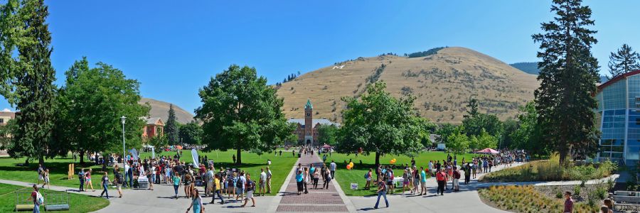 view of crowded UM oval with University Hall on the opposite end