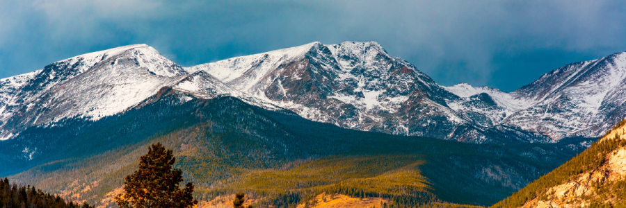 row of tall mountains covered in snow