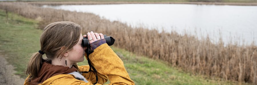 UM student looks through binoculars.
