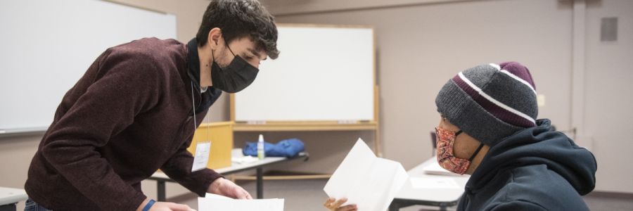 student reviewing documents with another student