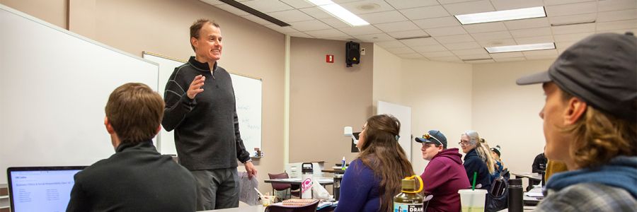 professor teaching viewed as if we are sitting in the classroom
