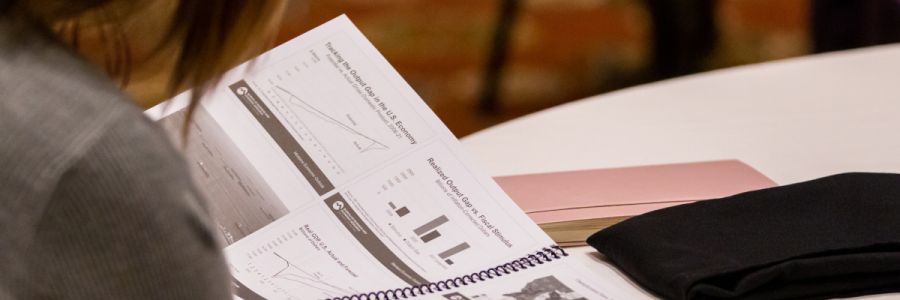 student reviewing graphs of economy data in a textbook