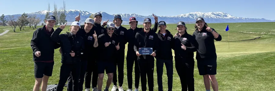 Members of UM Club Golf Team hold a trophy as they celebrate a win