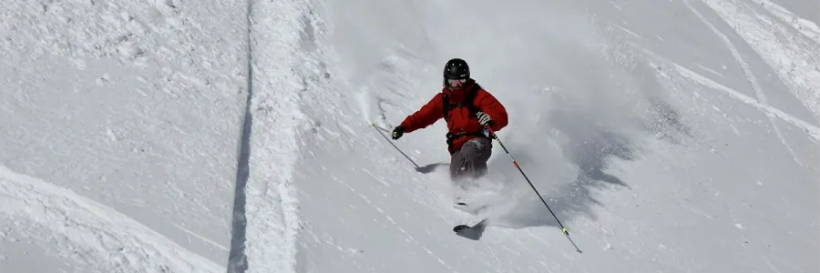 A telemark skier makes powder turns