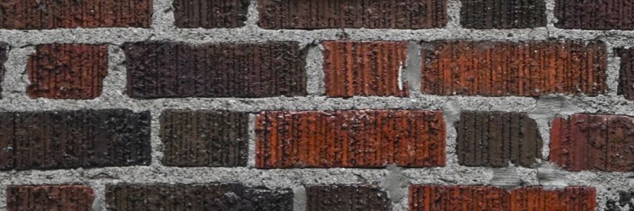 close up of a red brick wall with mortar