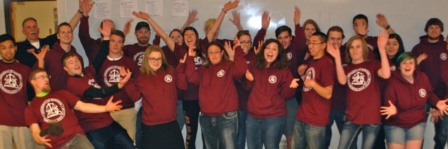 two rows of criminology club students holding their hands up and making faces