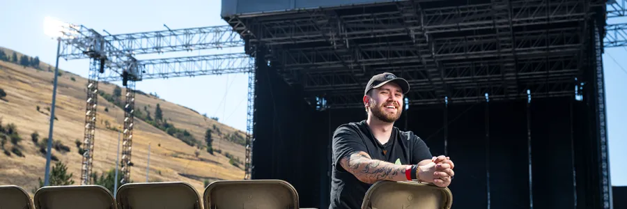 Marley Miller stands for a portrait on the stage built in Washington - Grizzly Stadium on the 91视频 campus for the summer concert series.