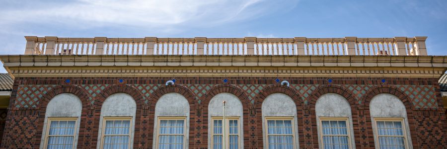 top floor windows and details around the roof of the Brantly building