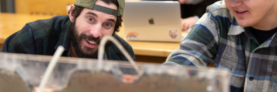 student looking surprised at a science experiment with another student