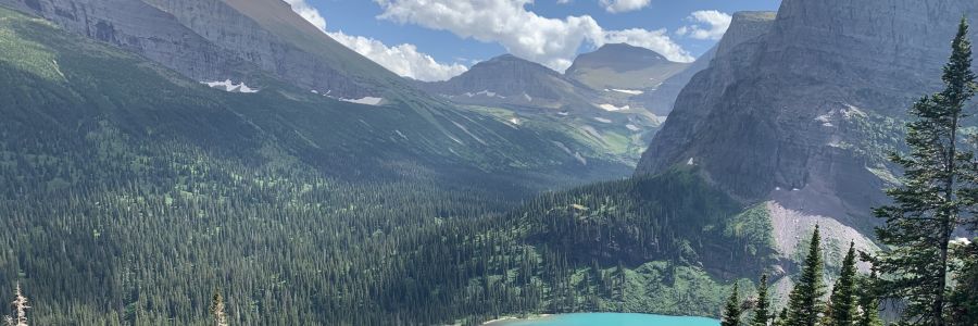 small, steep mountain valley seen from above with small lake below