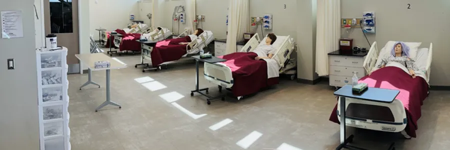 human mannequins laying in a row of five hospital beds in a Missoula College classroom