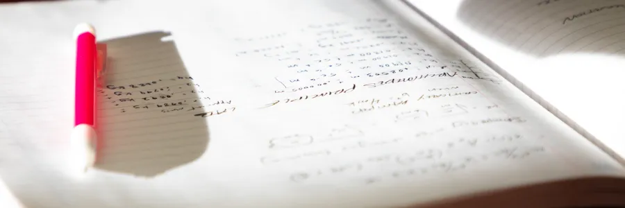 A pencil casts a long shadow across a notebook in a Physics 217 lab held in the Clapp Building on the University of Montana campus in Missoula, MT.