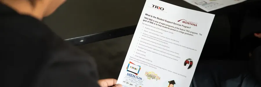 student looking at a page detailing the Trio student support services