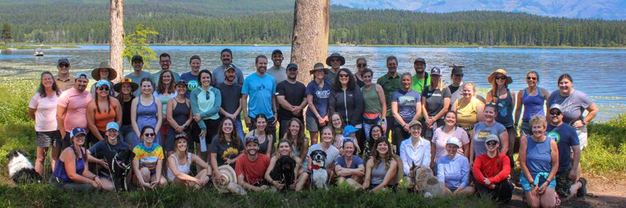 members of Western Montana Family Medicine posing together on the banks of a lake