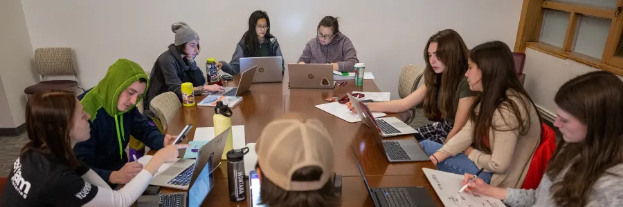 UM students working together at Study Jam, using laptops and notebooks in a bright, collaborative space