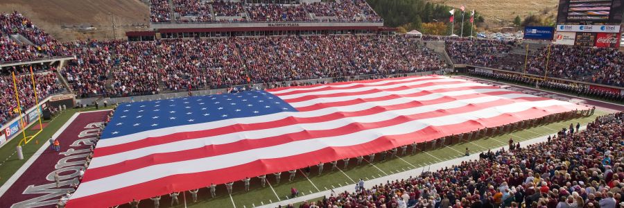 large american flag being held open on the entire field of Washington Grizzly stadium