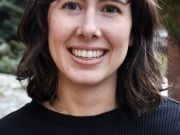Portrait of the principal investigator, Rachel Williamson, for our lab website. A smiling woman with brown hair and brown eyes wearing a black shirt, looking towards the camera.
