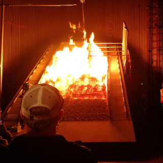 Students look at the burn chamber at the Missoula Fire Lab, a leading federal research facility 