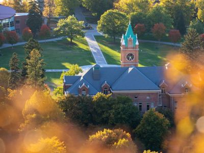 An image of the 91Ԫ clock tower with orange leaves in the foreground