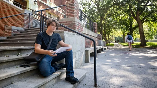 A student reviews notes from class outside the Fine Arts Building at the University of Montana