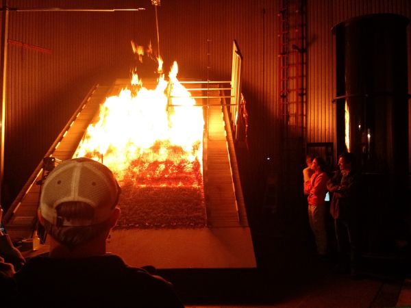 Students look at the burn chamber at the Missoula Fire Lab, a leading federal research facility 