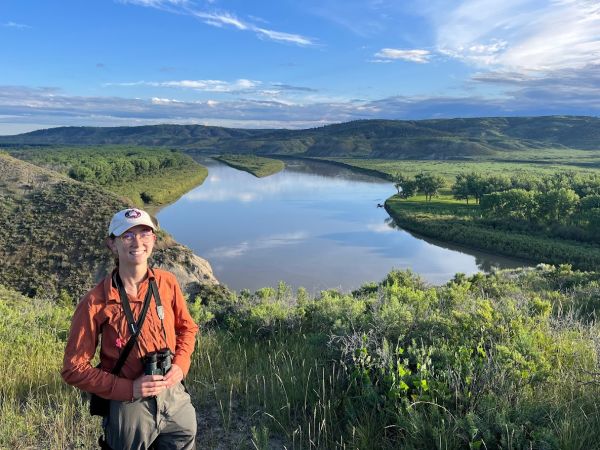 Anna Kurtin stands in front of a eastern Montanan riparian area